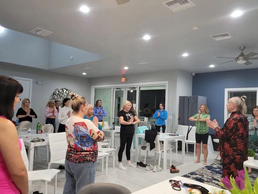 Adults practicing Qigong with Master Iurii Khomiakov in a bright group-class studio